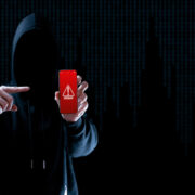 Scammer holding a smartphone.