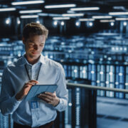Man operating a data centre with a tablet computer.