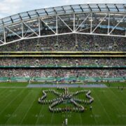 College band marching in shape of shamrock at Aviva Stadium.