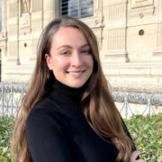 Brown haired woman in dark top.