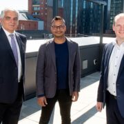 Three men on a roof in Belfast.