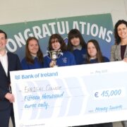 Students hold a large cheque.+