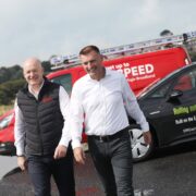 Two men beside a beach.