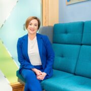 Woman in navy blue suit.