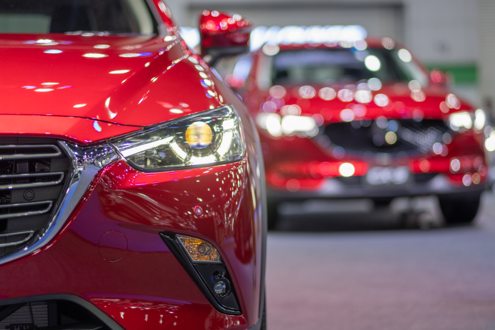 shiny new red cars in showroom.