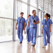 Doctors and nurses in blue gowns.