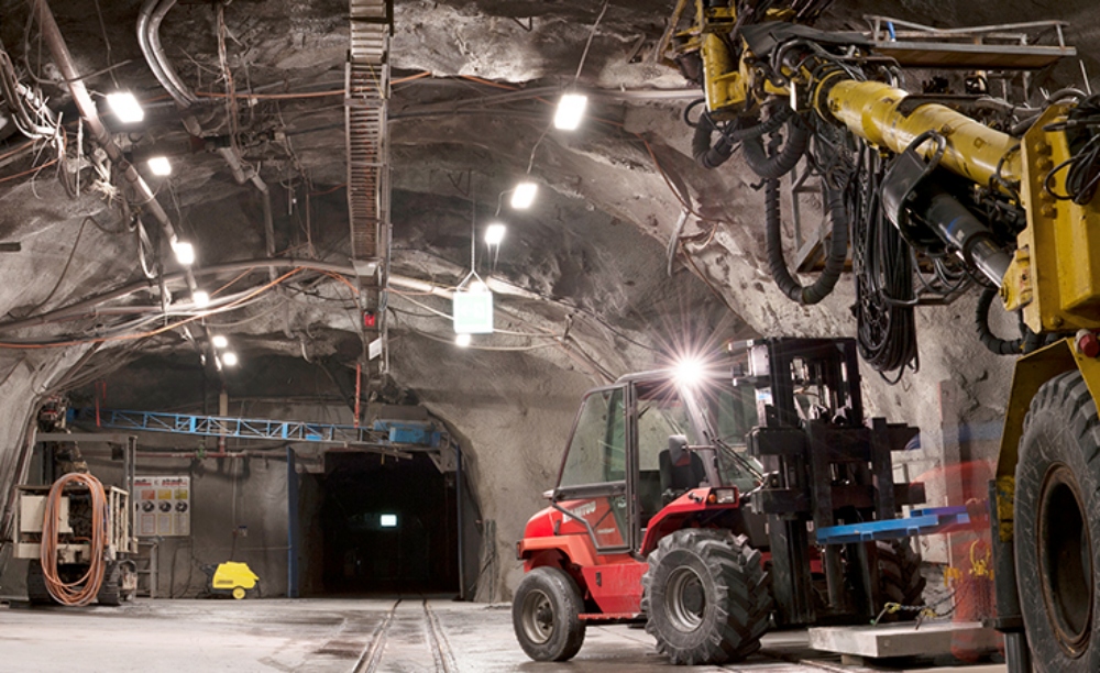 underground tunnel with electric mining vehicles.