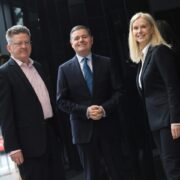 Two men and a woman at an event.