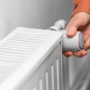 Worried consumer turning down heat amid energy crisis.