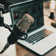 Podcast microphone beside laptop.