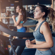 Women on treadmills in a gym.