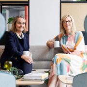 Two business women drinking coffee.