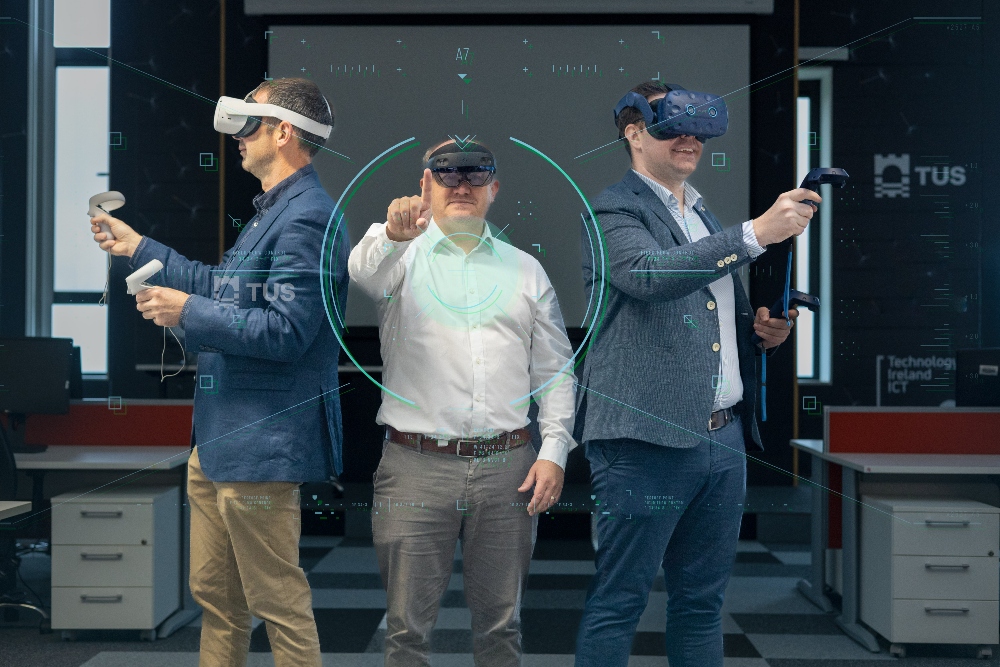 Three men wearing VR goggles.