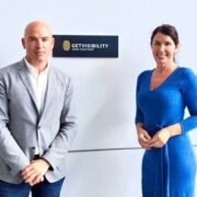 Man in grey jacket and woman in blue dress.