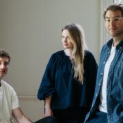 Two men and a woman in an office.