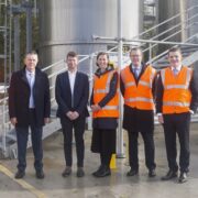 Group of people at an industrial facility.