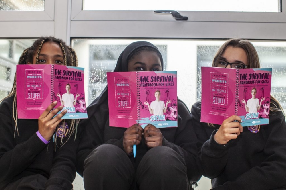 three young women reading books.