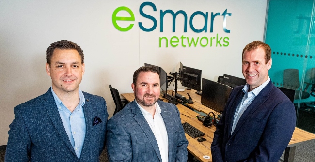 Three men in front of eSmart brand.