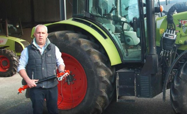 Man standing beside a tractor.