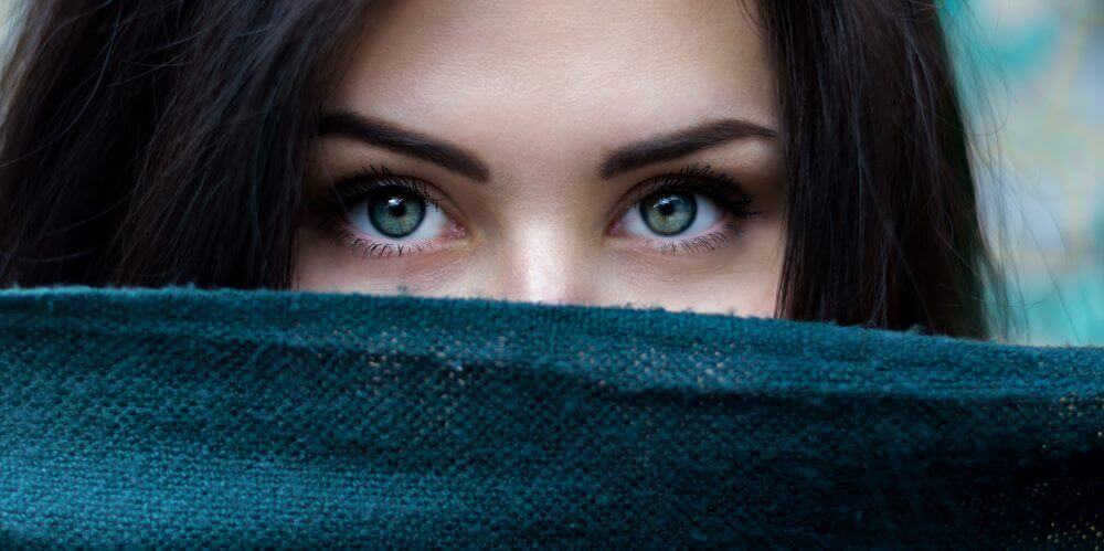 Close-up of woman with green eyes.