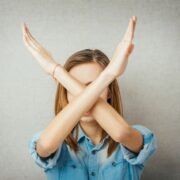 Customer with arms crossed saying no.