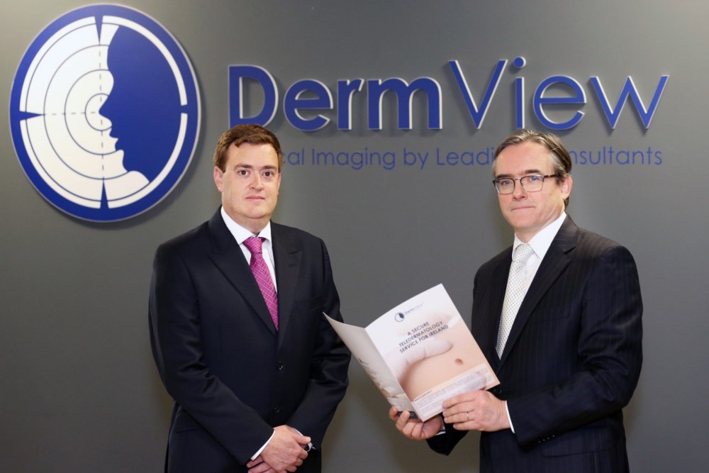 Two men under a sign saying DermView.