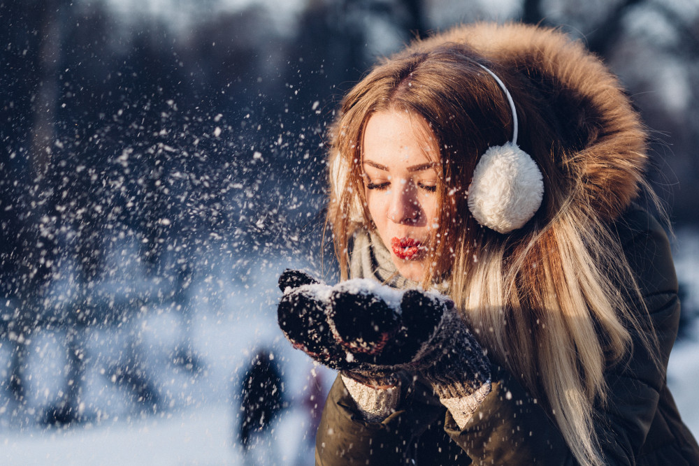 woman in snow wearing warm clothing.