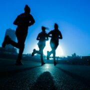 People jogging under a winter sky.