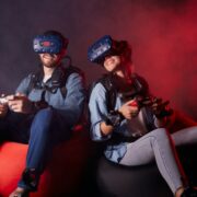 Man and woman wearing VR headsets.