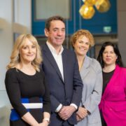 Man and three women in a bank.