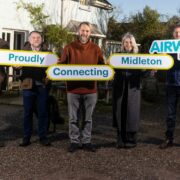 5 people holding signs.