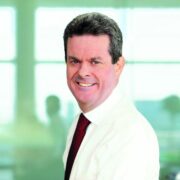 Businessman in white shirt and wine tie.