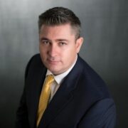 Man in suit with yellow tie.