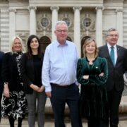 Group of men and women outside Government buildings in Dublin.