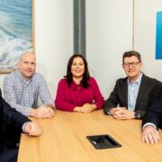 Group of people at a boardroom table.