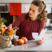 Woman looking at shopping receipt.