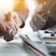 Businessman and woman shaking hands on a deal.