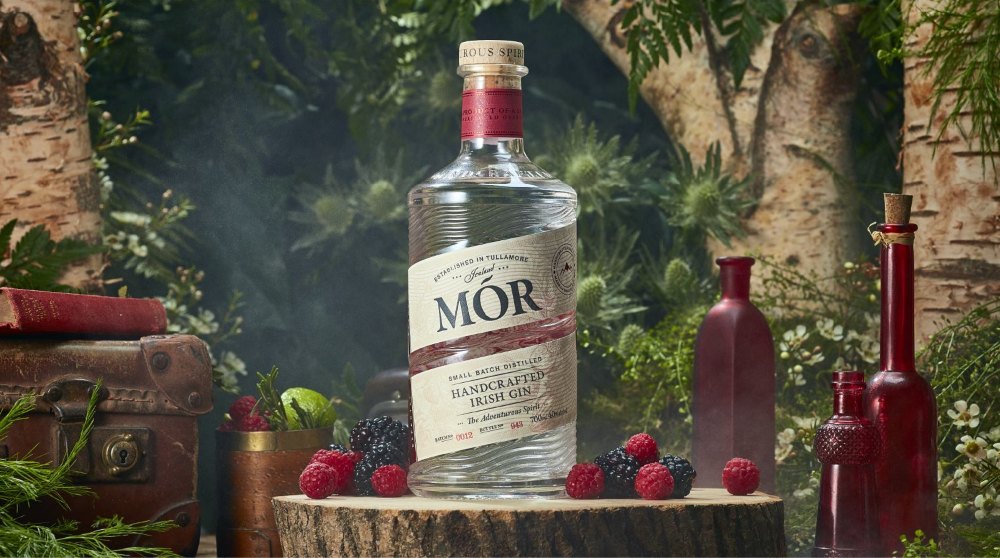 Bottle of Mor Irish Gin surrounded by berries.