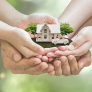 Couple hold a model of dream home.