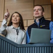 Young graduates on a stairs.