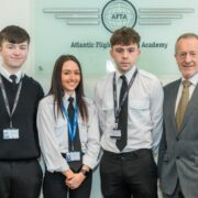 Three men and a woman at a flight school.