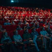 people enjoying a movie at cinema theatre.