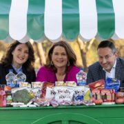 Man and two women inside a food cart.