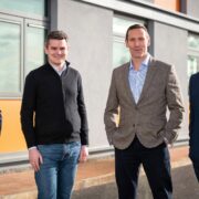 Four men outside a building.