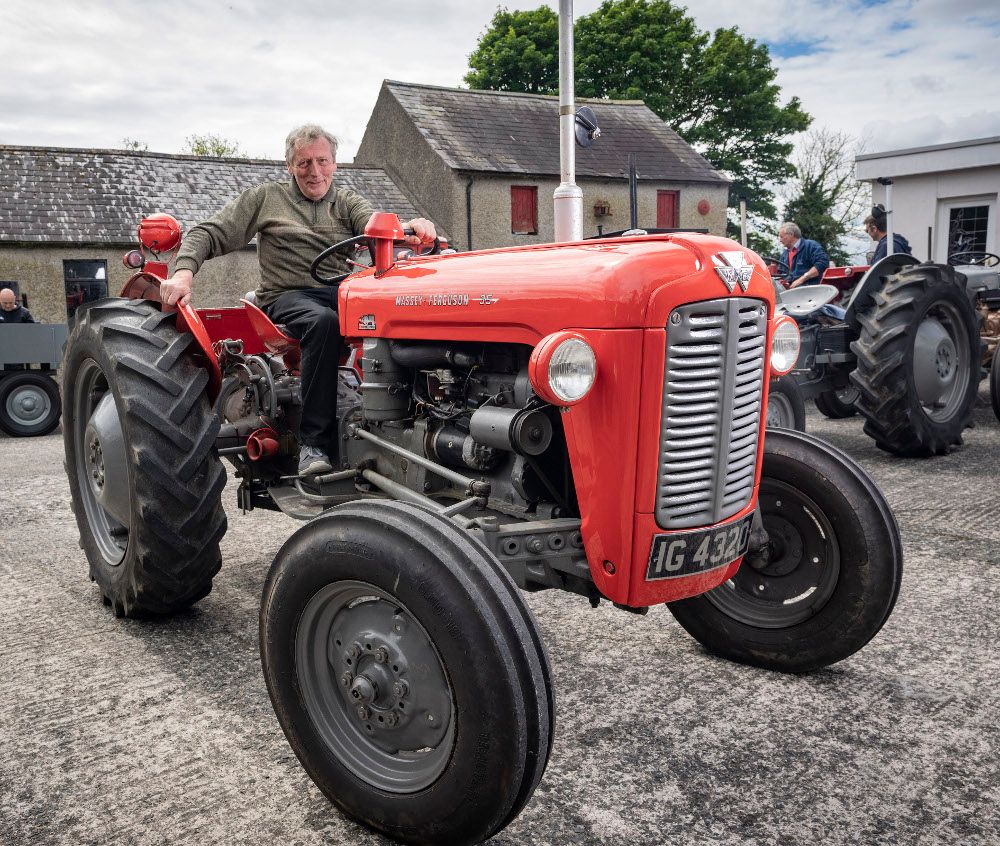 Man sitting on red tractor.