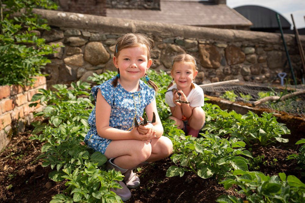 Young girls gardening.