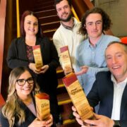 Three men and two women holding awards.