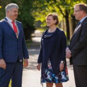 Two men and a woman talking.