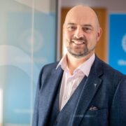 Smiling man in suit.