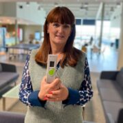 Woman holding a medical device.